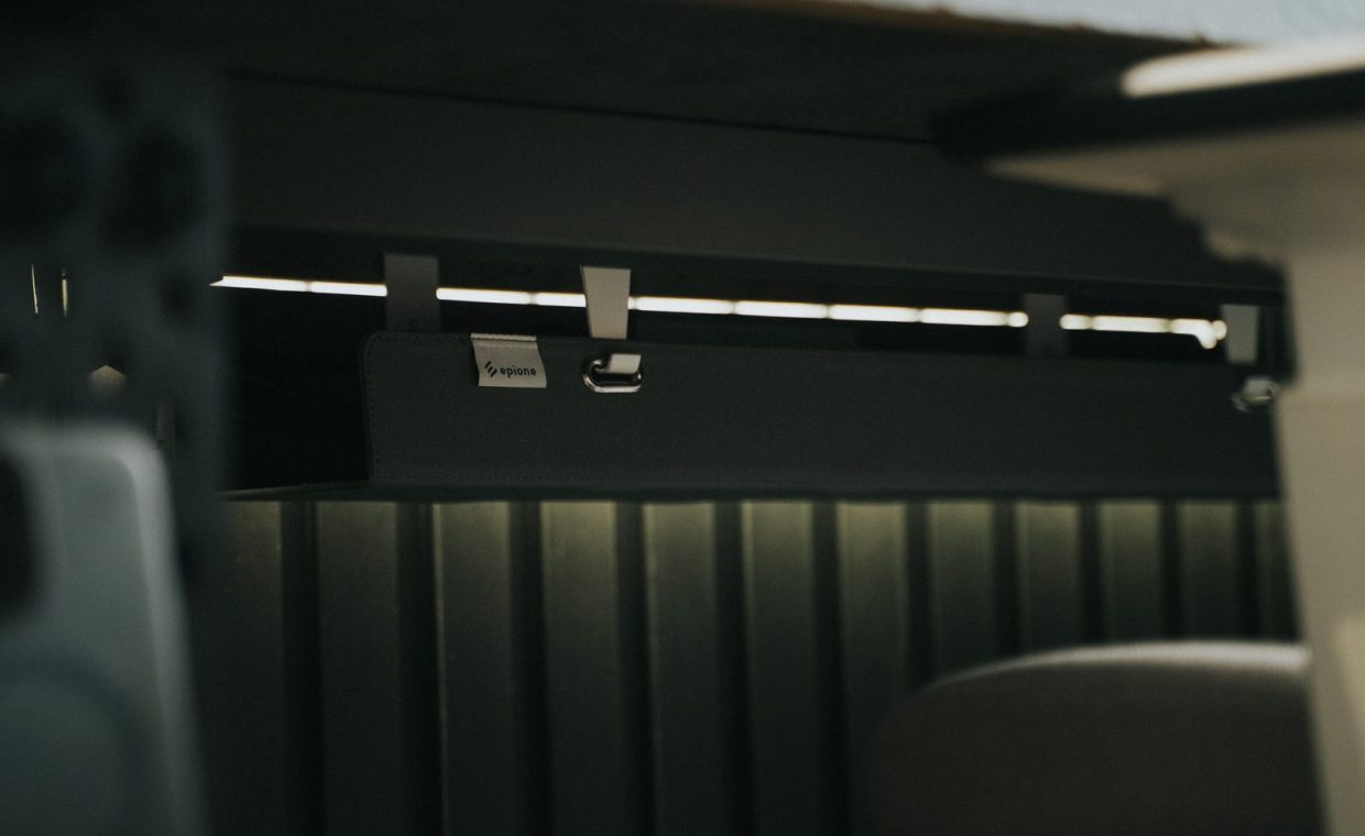 Close-up view of sleek under desk cable management in an office setting, enhancing workspace organization.