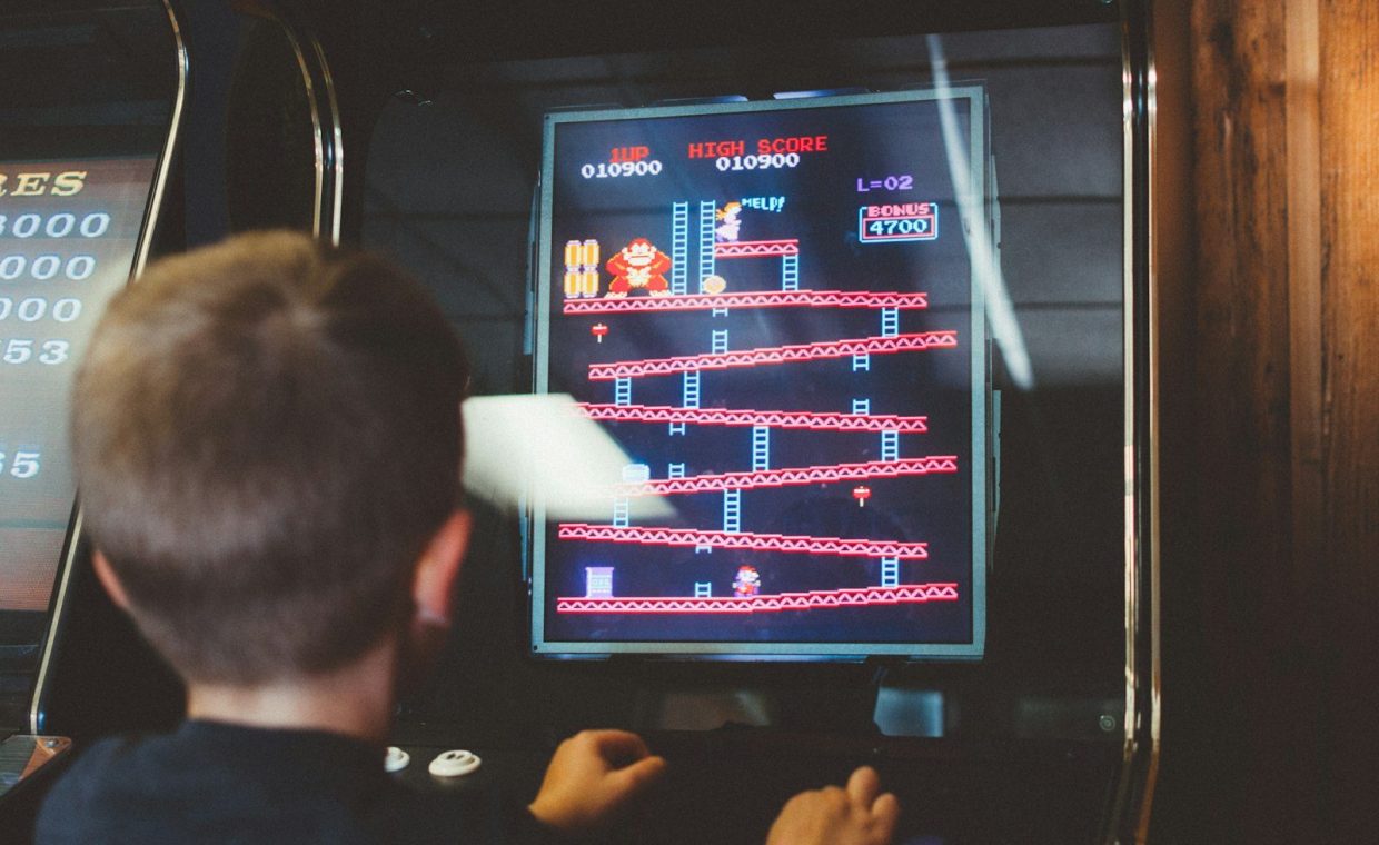 boy playing donkey kong arcade box
