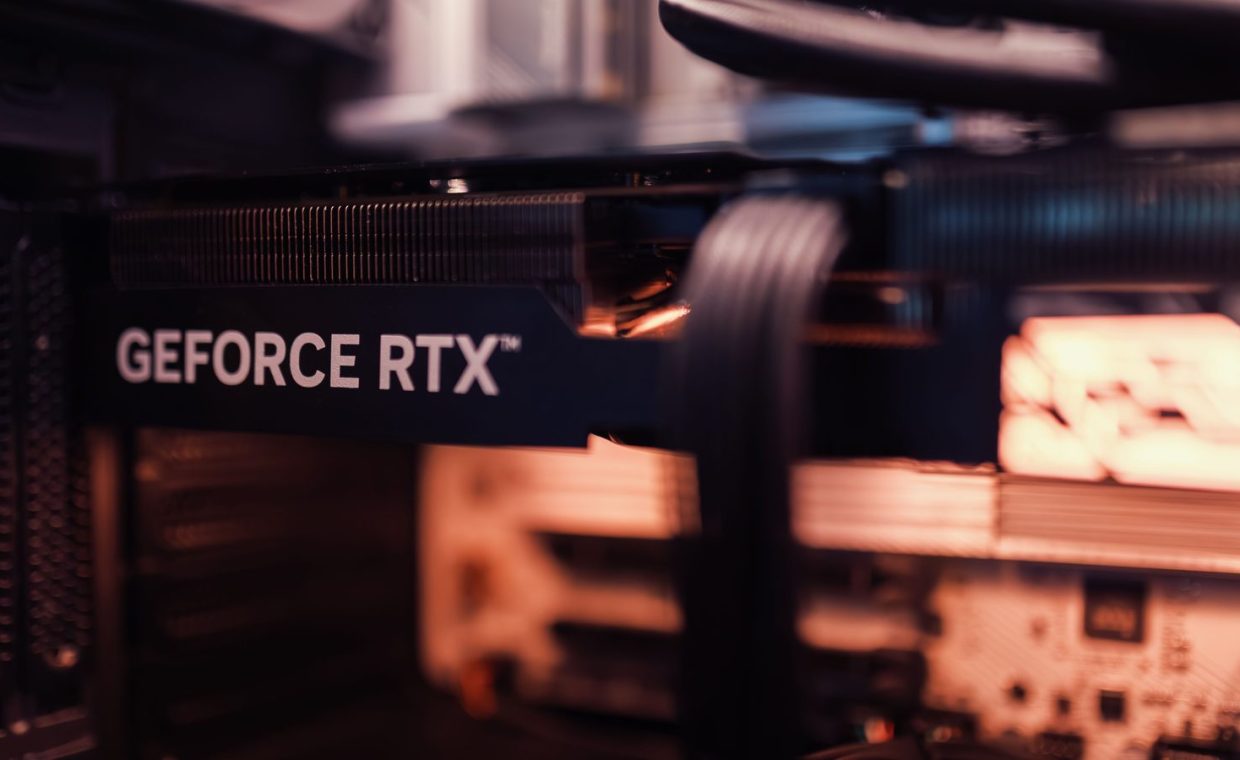 Detailed view of a GeForce RTX graphics card installed in a computer setup, highlighting modern technology.