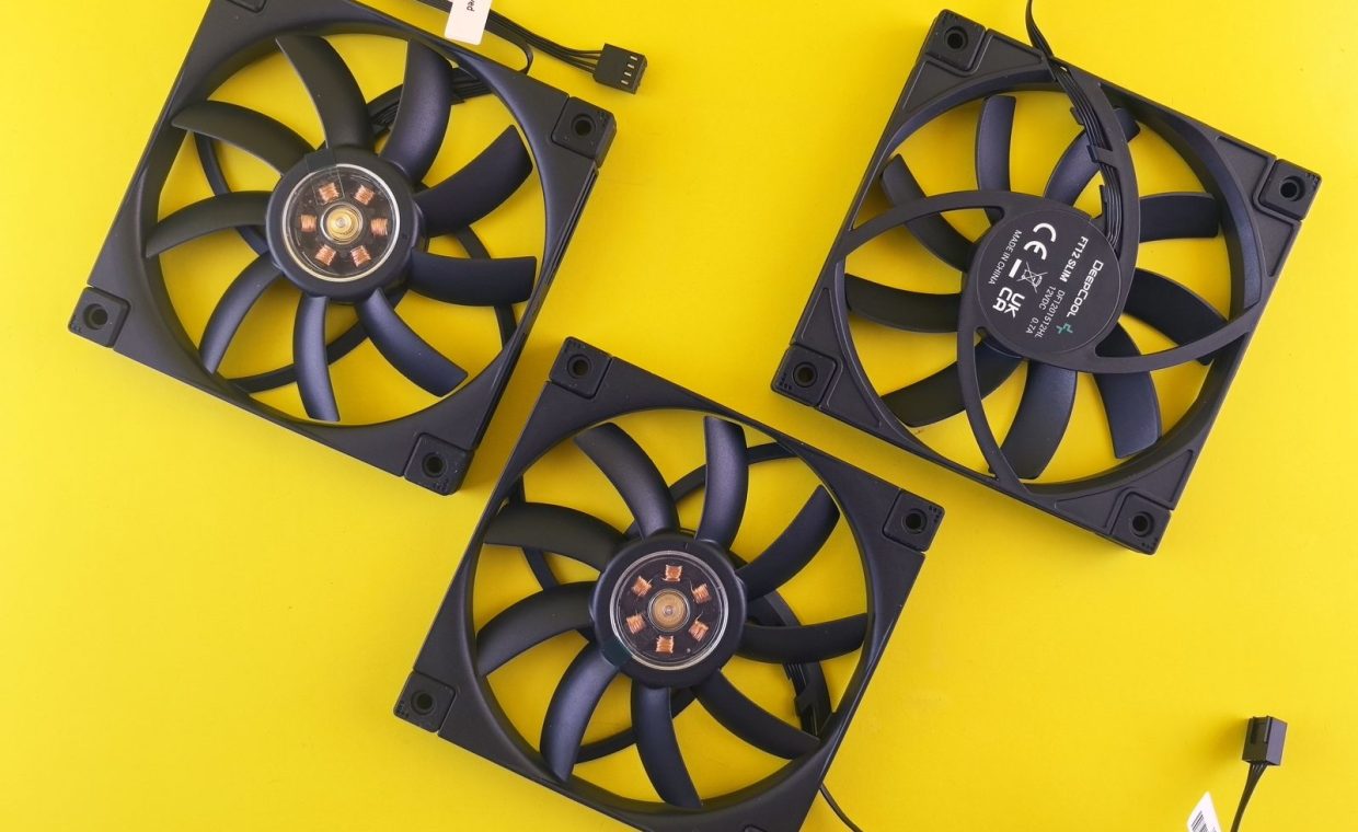 Three black computer cooling fans arranged on a vivid yellow backdrop, perfect for tech themes.