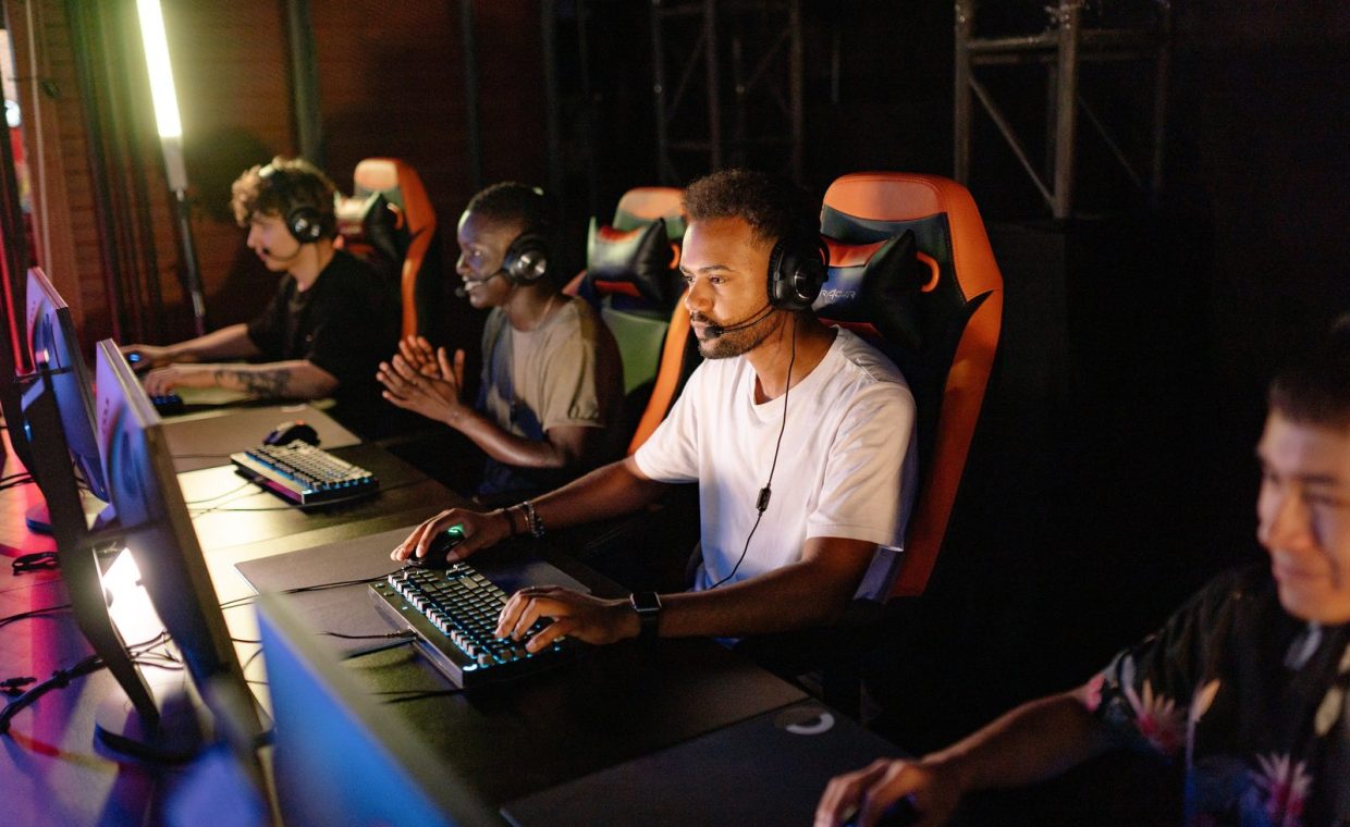 A group of young adults intensely focused on a competitive esports tournament indoors.