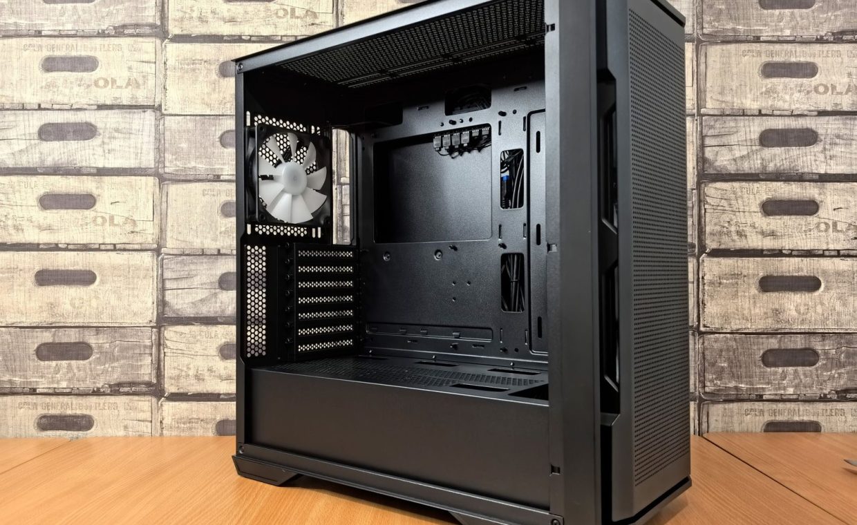 Open computer case with mounted fan, showcasing modern PC design and interior space.