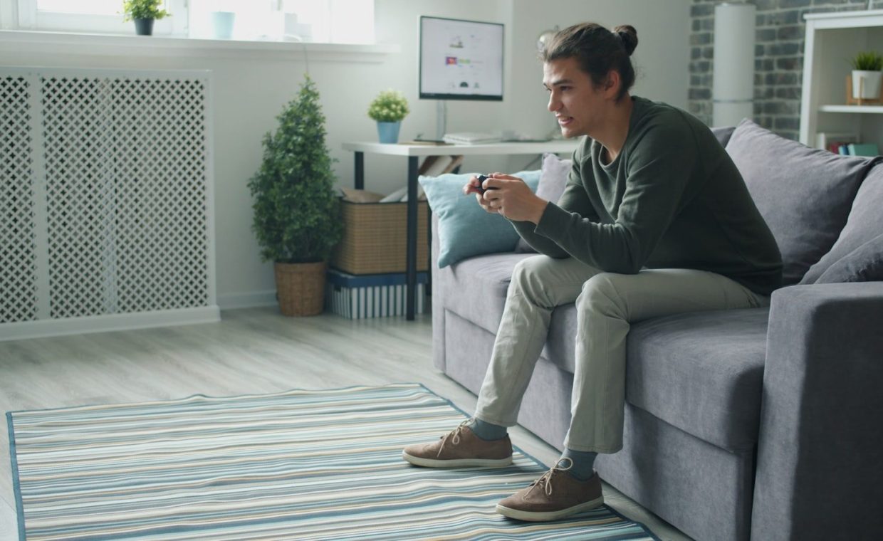 Man playing video games on couch