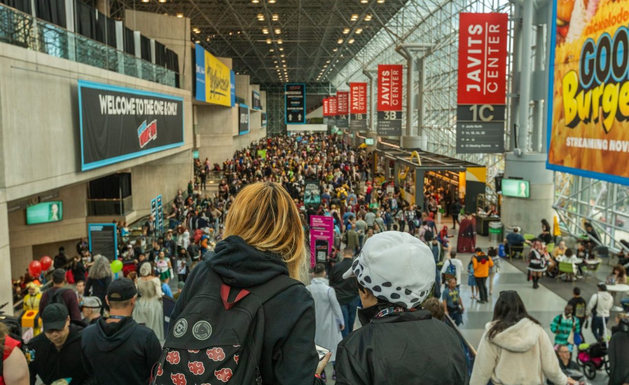 Lively crowd at New York Comic Con in Javits Center, showcasing cosplay and fan culture.