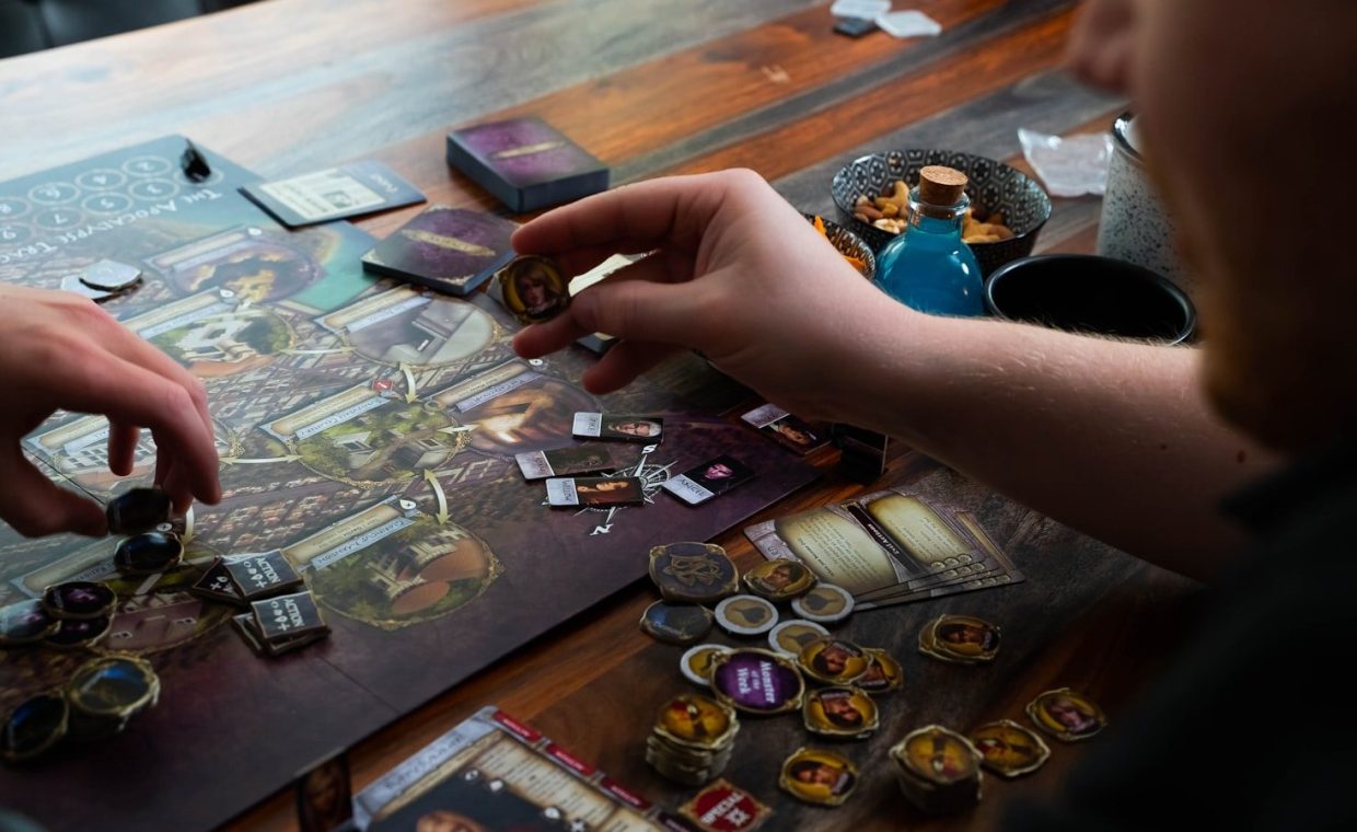 two people playing a board game on a table